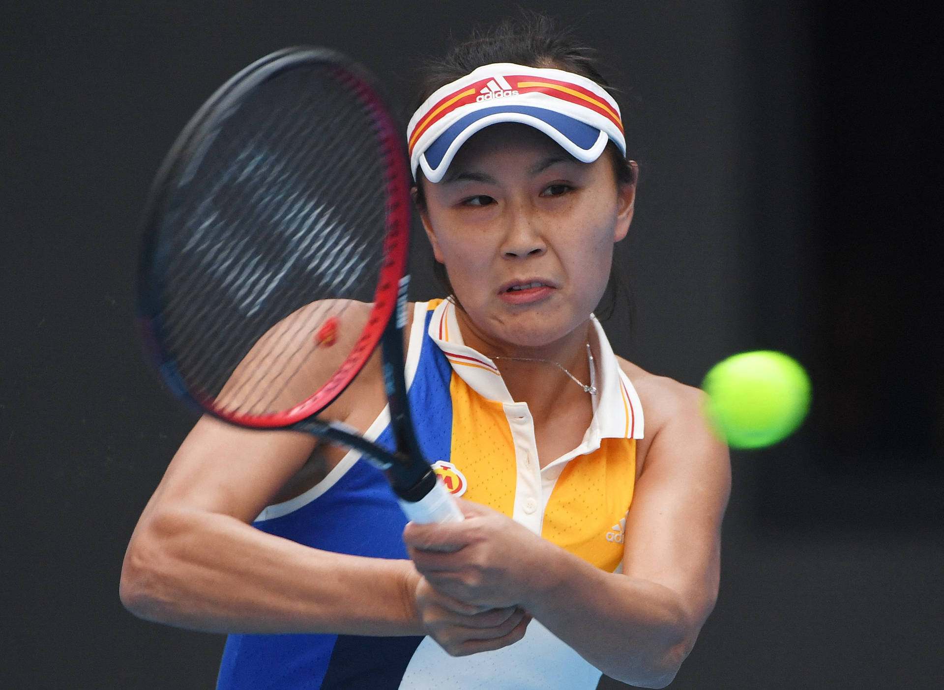 Caption: Shuai Peng In Action With Her Signature Double-hand Grip Background