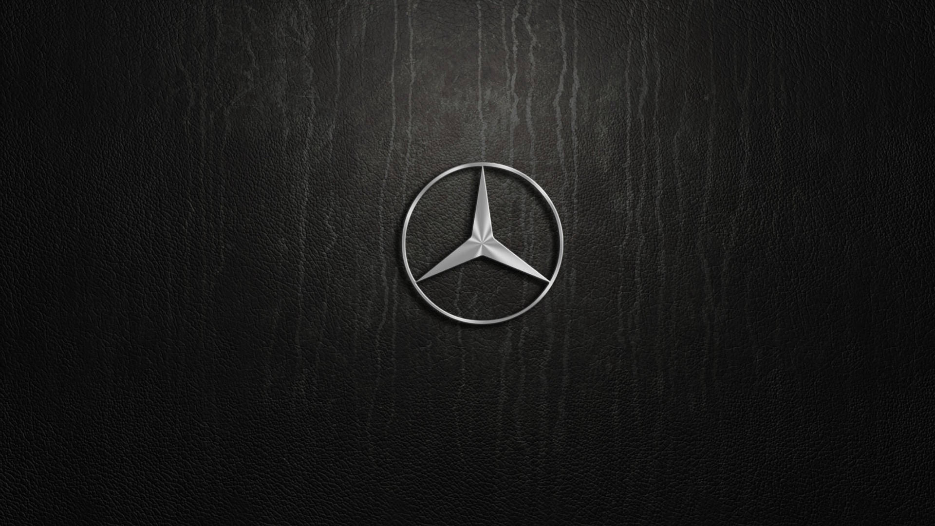 Caption: Silver Mercedes-benz Emblem Artistically Displayed Background