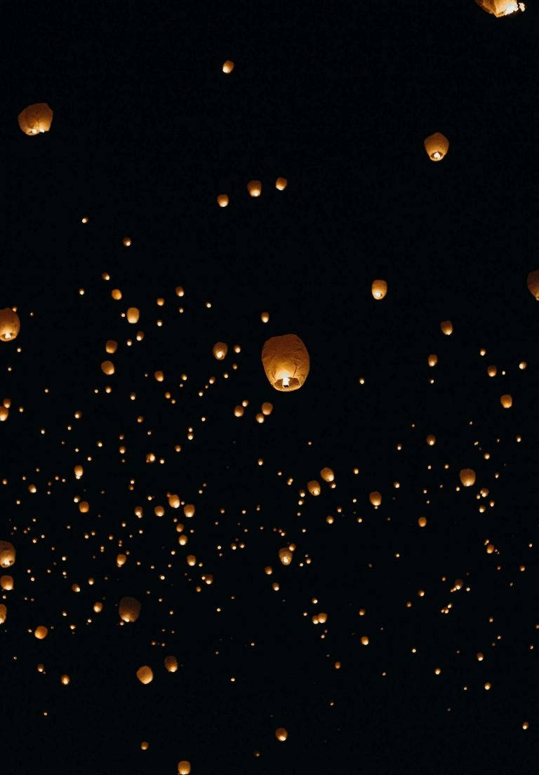 Caption: Sky Lanterns Reflected In Night Sky As Seen On Ipad 2021 Background