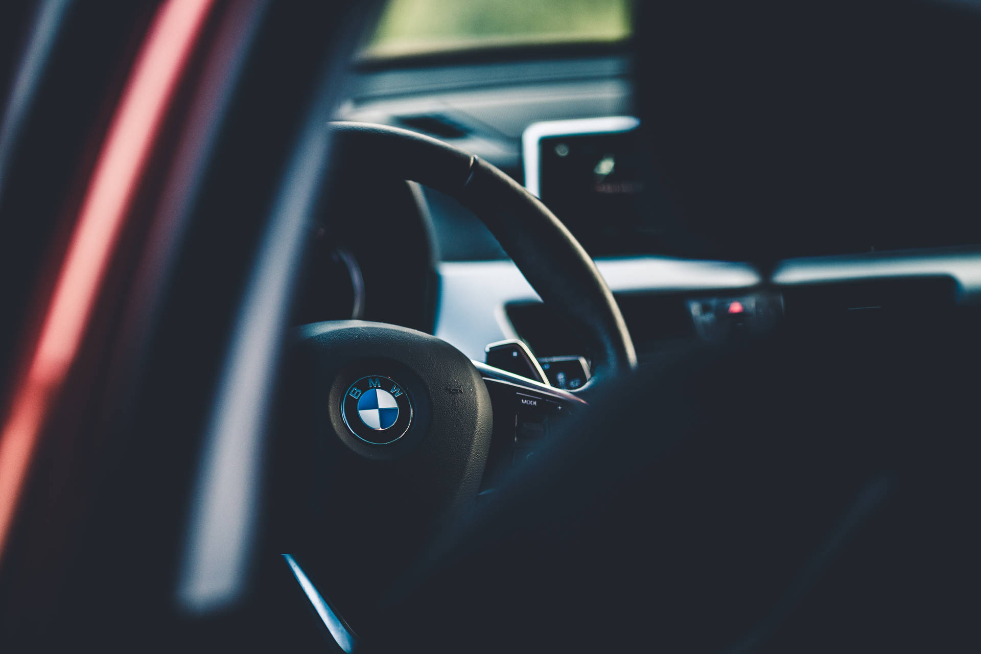 Caption: Sleek Black Bmw Cruising In The City Background