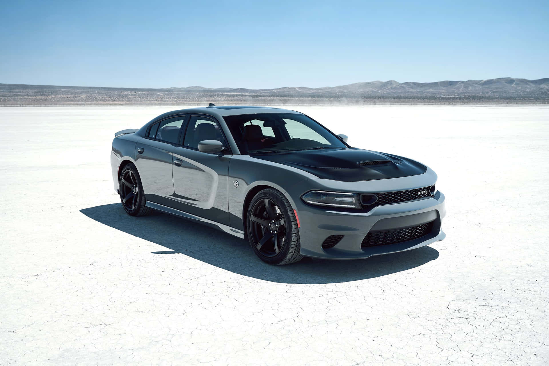 Caption: Sleek Black Dodge Charger On The Open Road Background