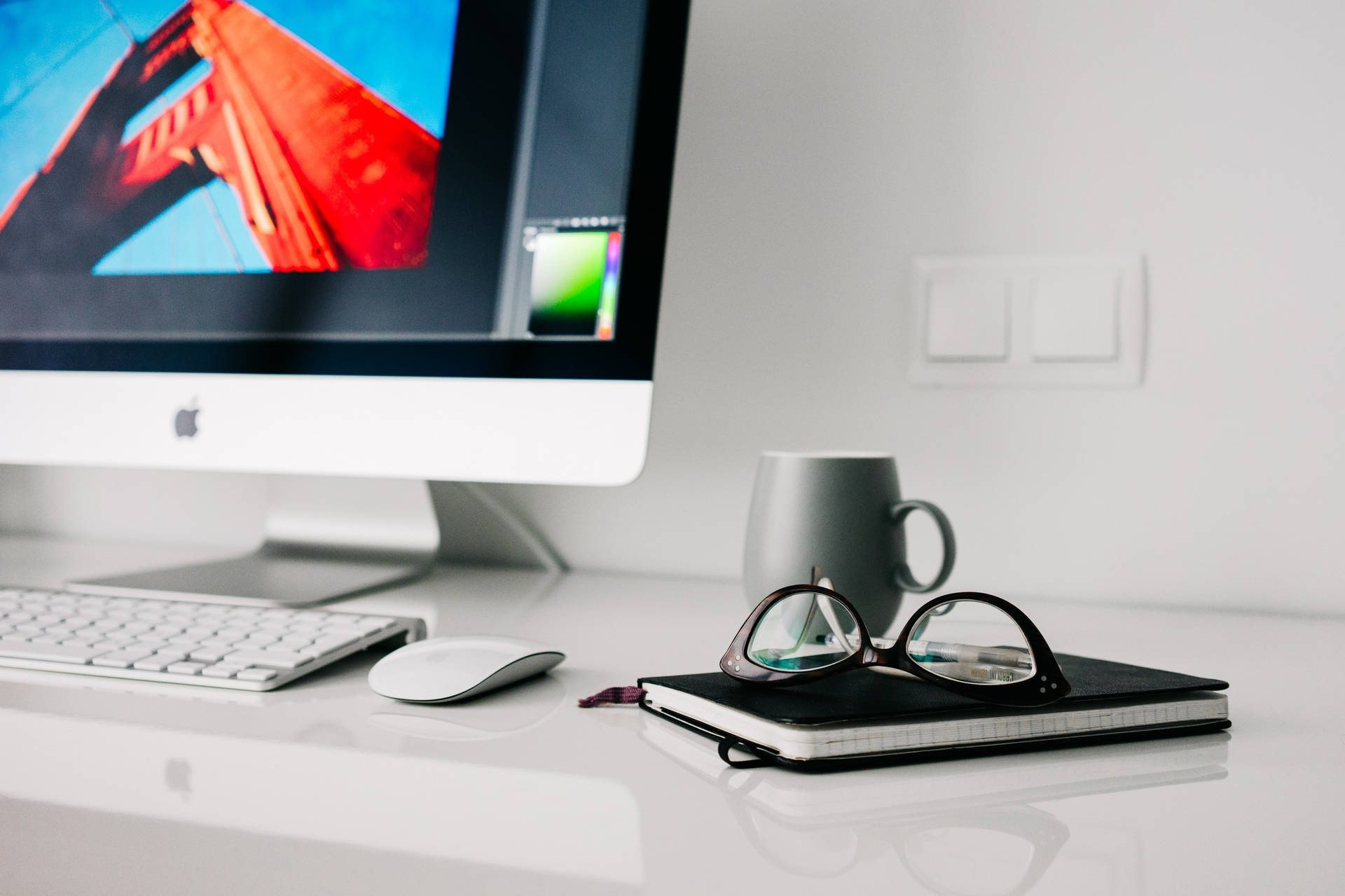 Caption: Sophisticated Mac Workspace Setup On A Clean Wooden Desk Background