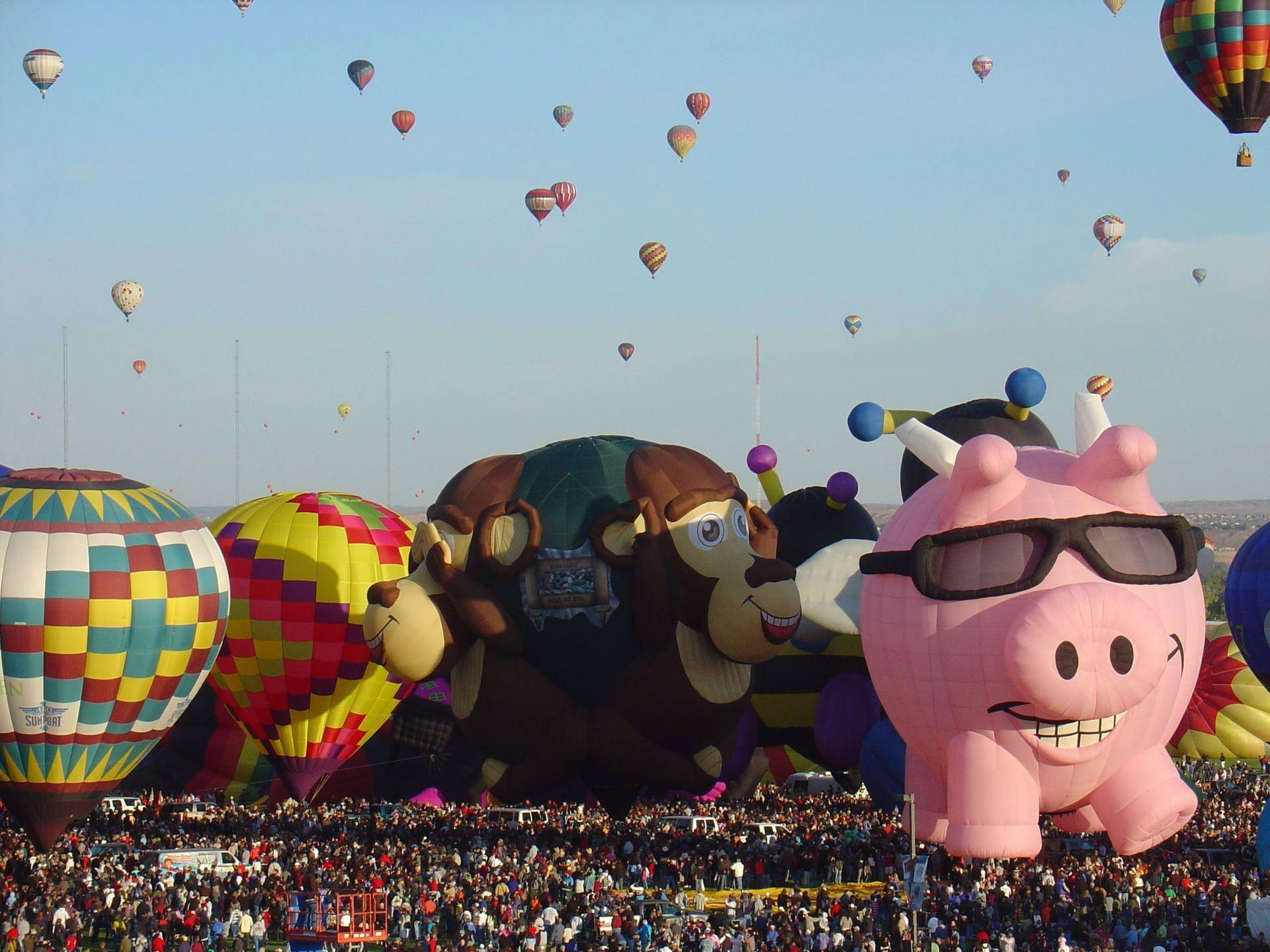 Caption: Spectacular Animal Hot Air Balloons Flying High Over Albuquerque Background