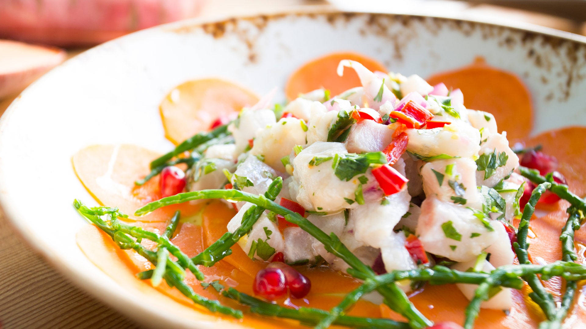 Caption: Spicy Ceviche Garnished With Herbs And Chilies Background