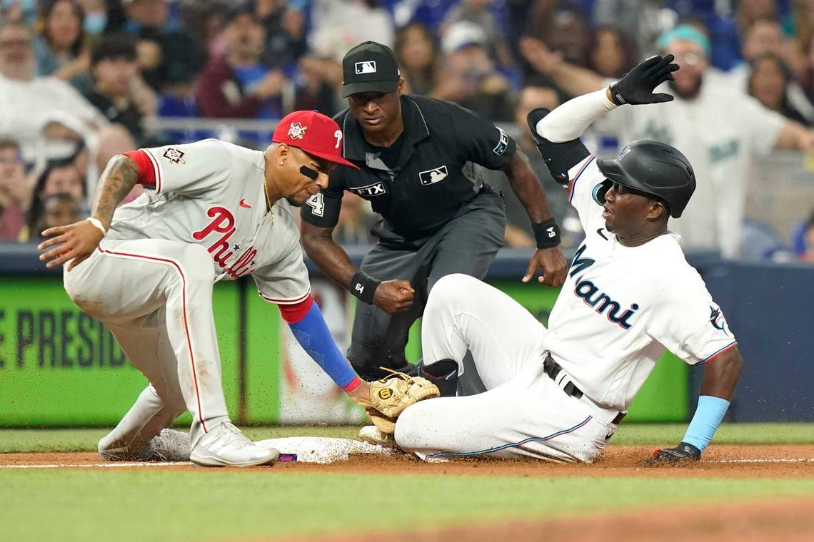 Caption: Spirited Clash Between Philadelphia Phillies And Miami Marlins At Major League Baseball Game Background