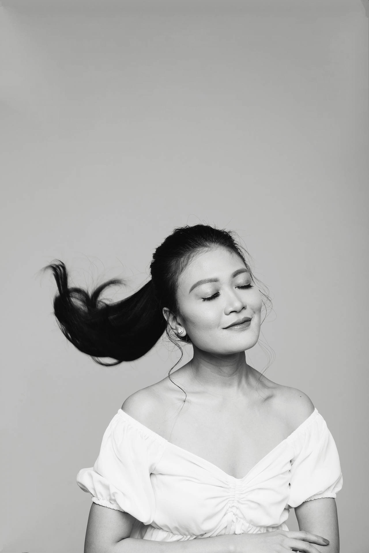 Caption: Striking Monochrome Portrait Of A Woman Flipping Her Ponytail Hair