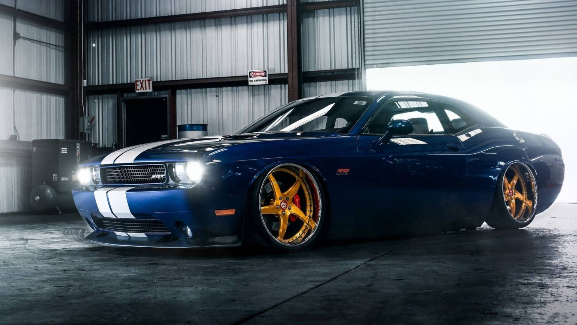 Caption: Stunning Blue Dodge Challenger Parked In Garage Background