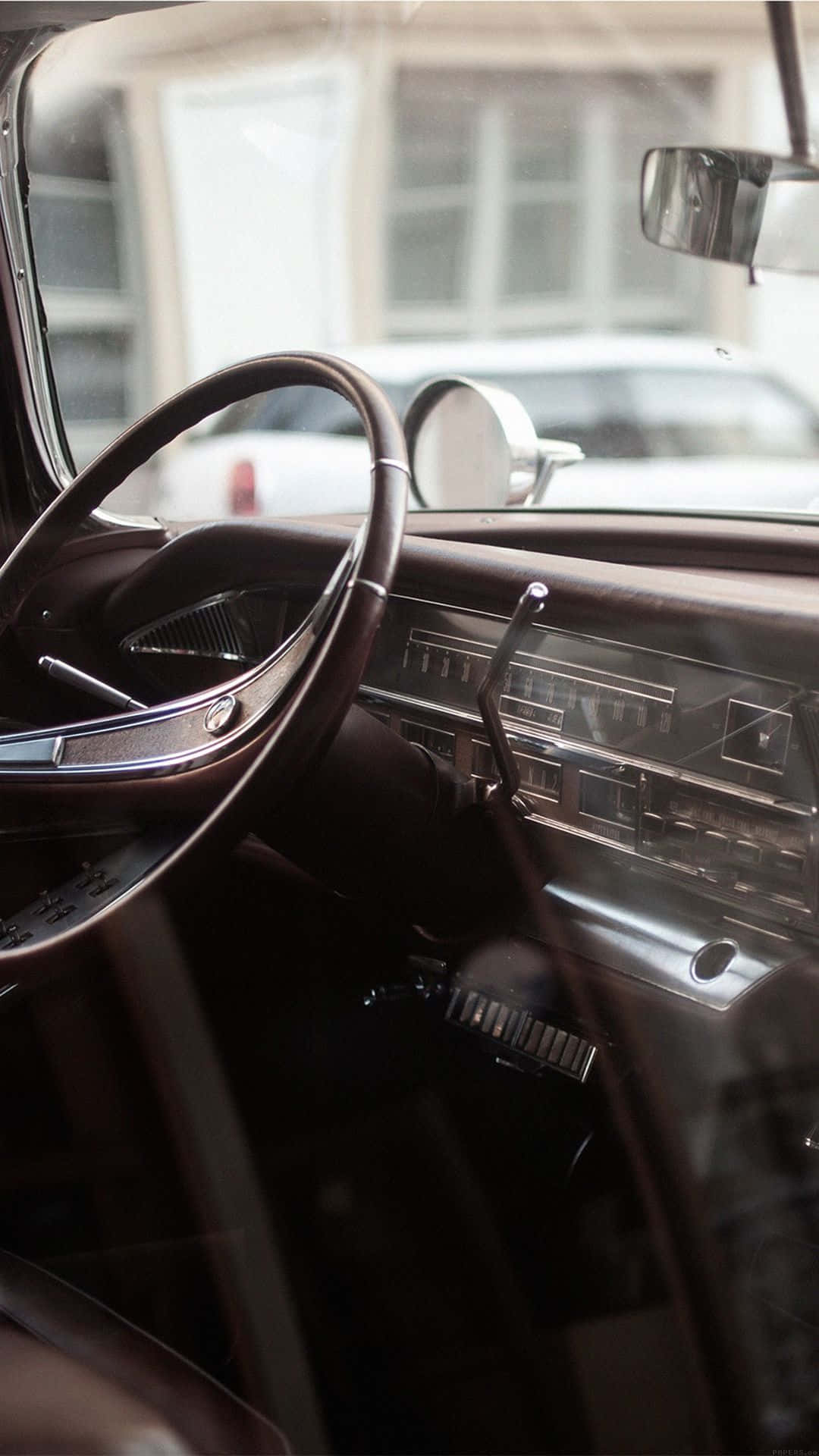 Caption: Stunning Classic Car Displayed On An Iphone Screen Background