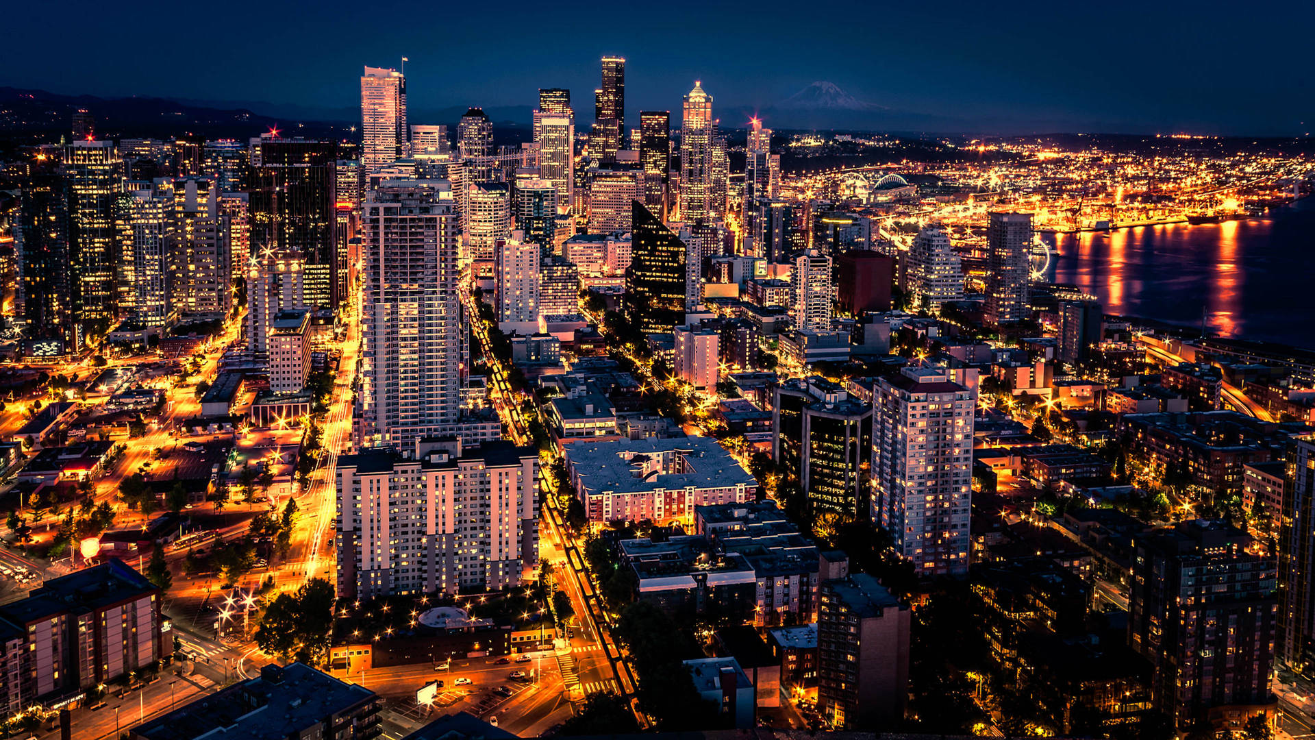 Caption: Stunning Night View Of Seattle Skyline Background