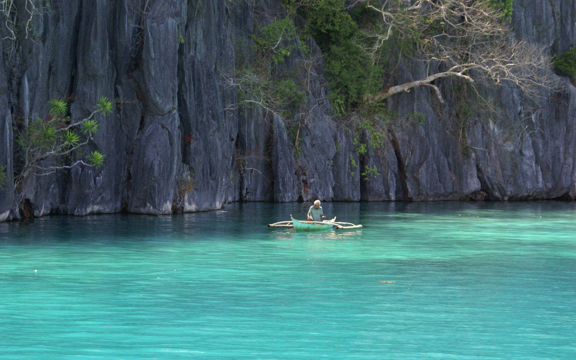 Caption: Stunning Views Of The Crystal Clear Waters In The Philippines Background