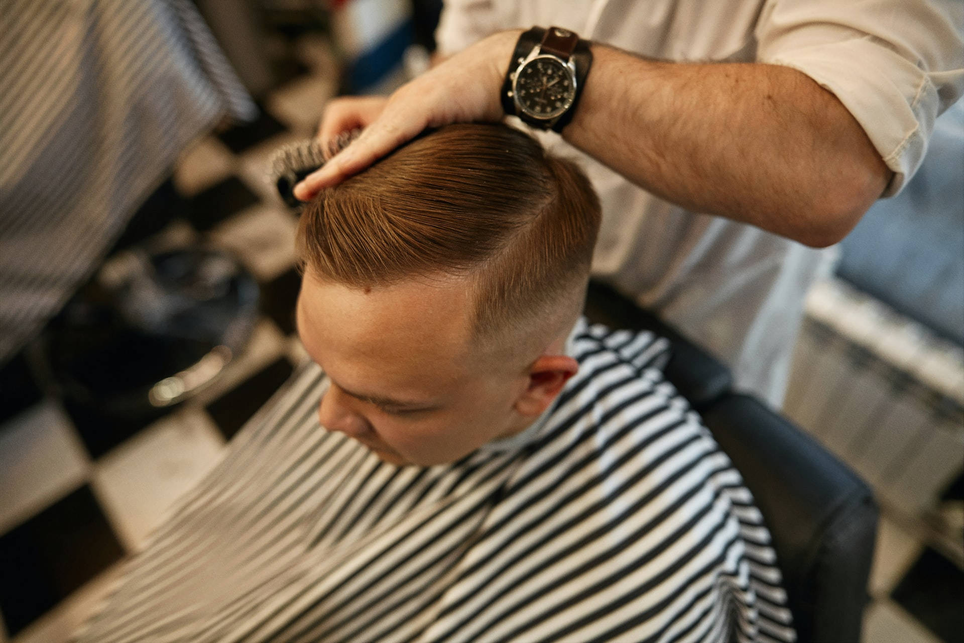 Caption: Stylish Sleek Side Part Men's Haircut Background