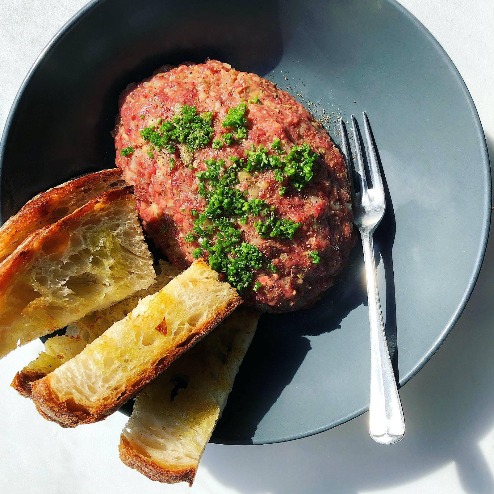 Caption: Succulent Steak Tartare Served With Bread Background