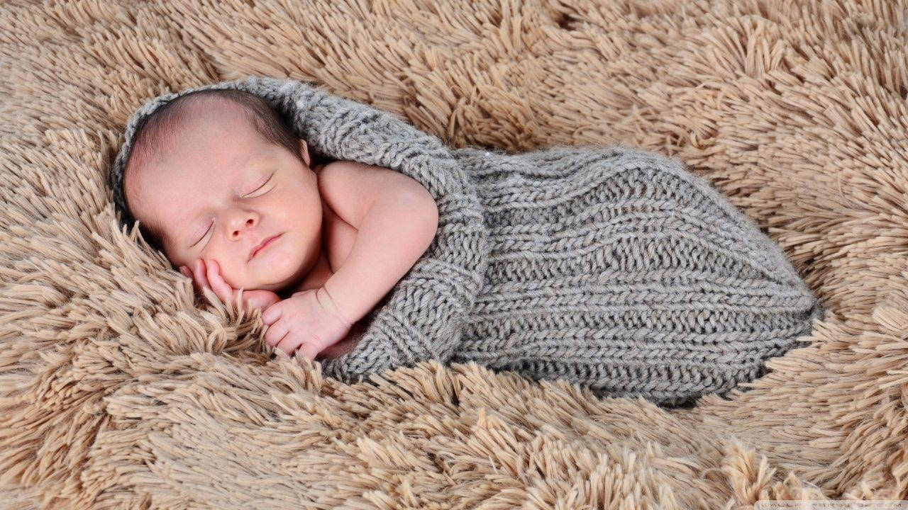 Caption: Sweet Dreams: Newborn Baby Sleeping Peacefully Background