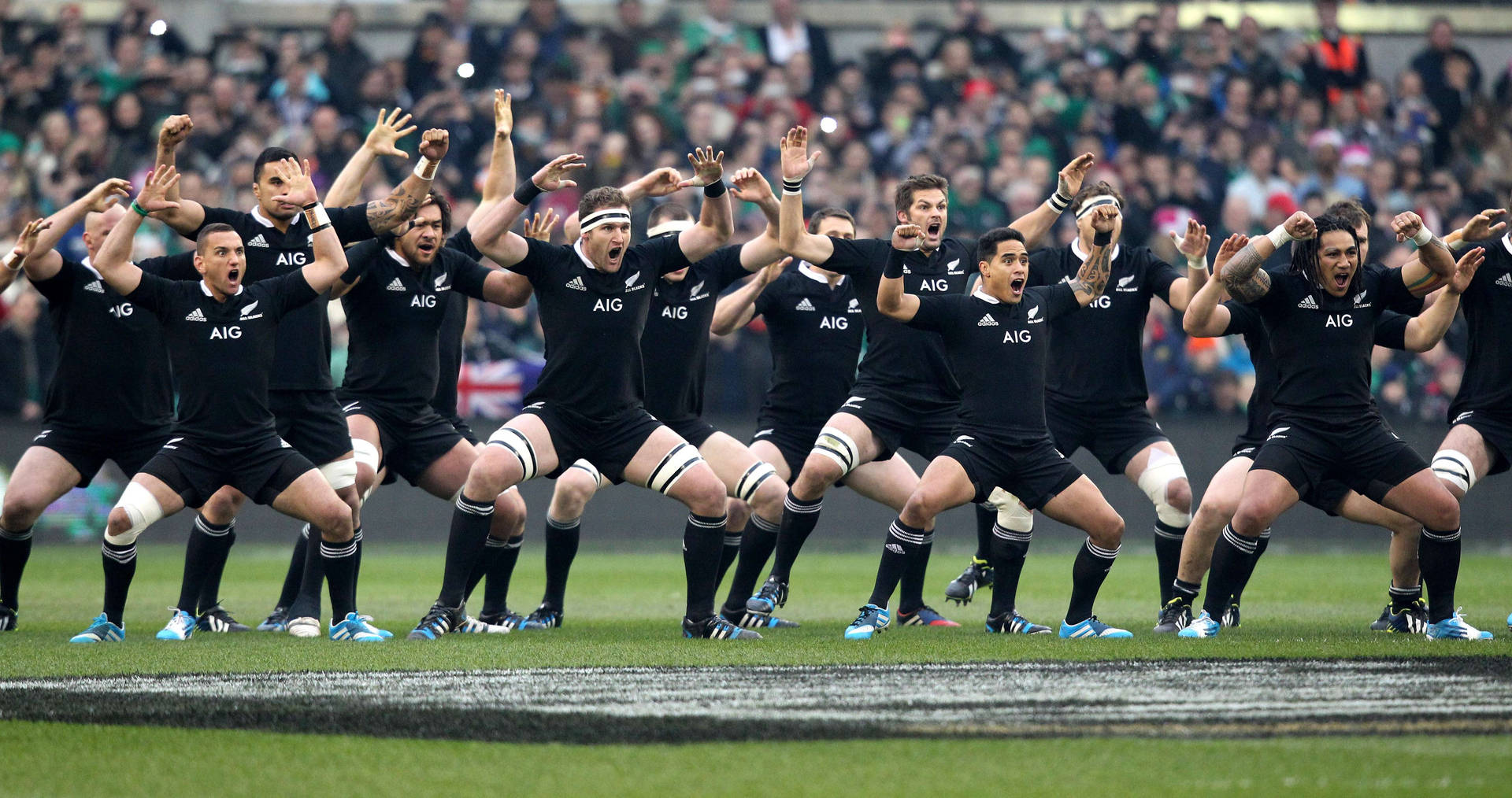 Caption: The All Blacks Rugby Team Performing The Haka Ritual Background