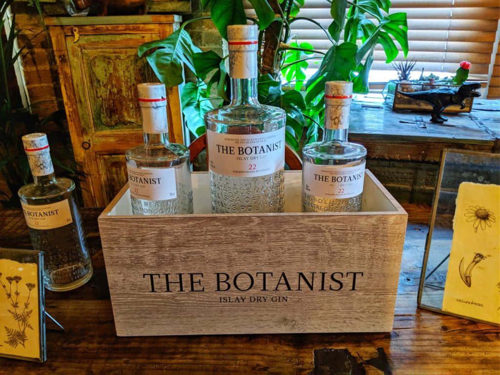 Caption: The Botanist Gin - A Premium Islay Dry Gin Displayed In A Unique Presentation Box Background