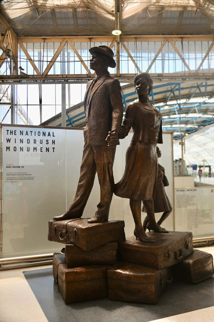 Caption: The Magnificent National Windrush Monument At Waterloo Station Background