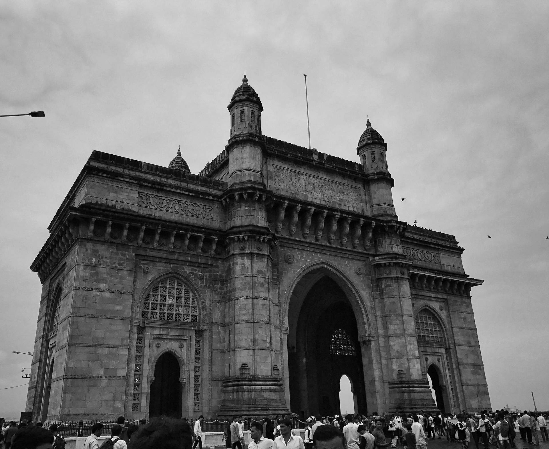 Caption: The Majestic Gateway Of Mumbai Under Ambient Skies