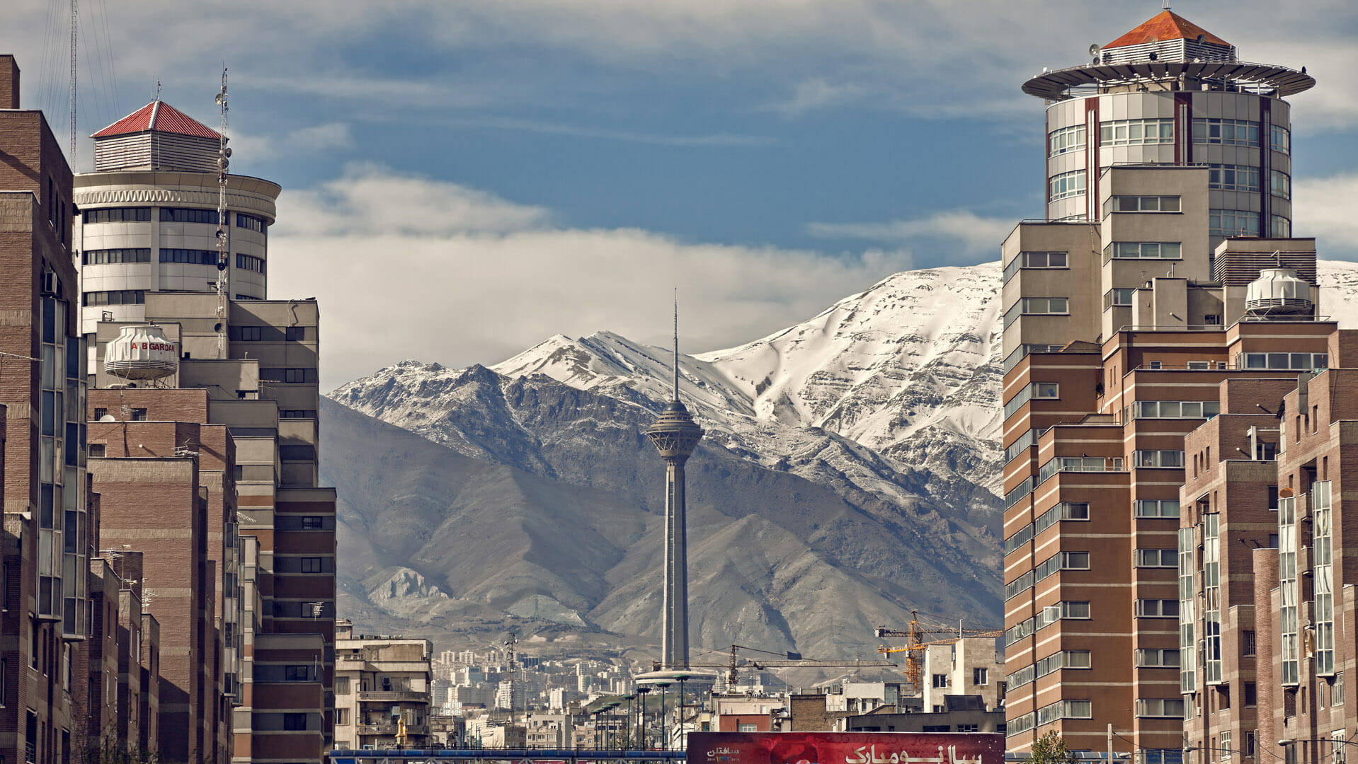 Caption: The Majestic Milad Tower Against The Skyline Of Tehran, Iran Background