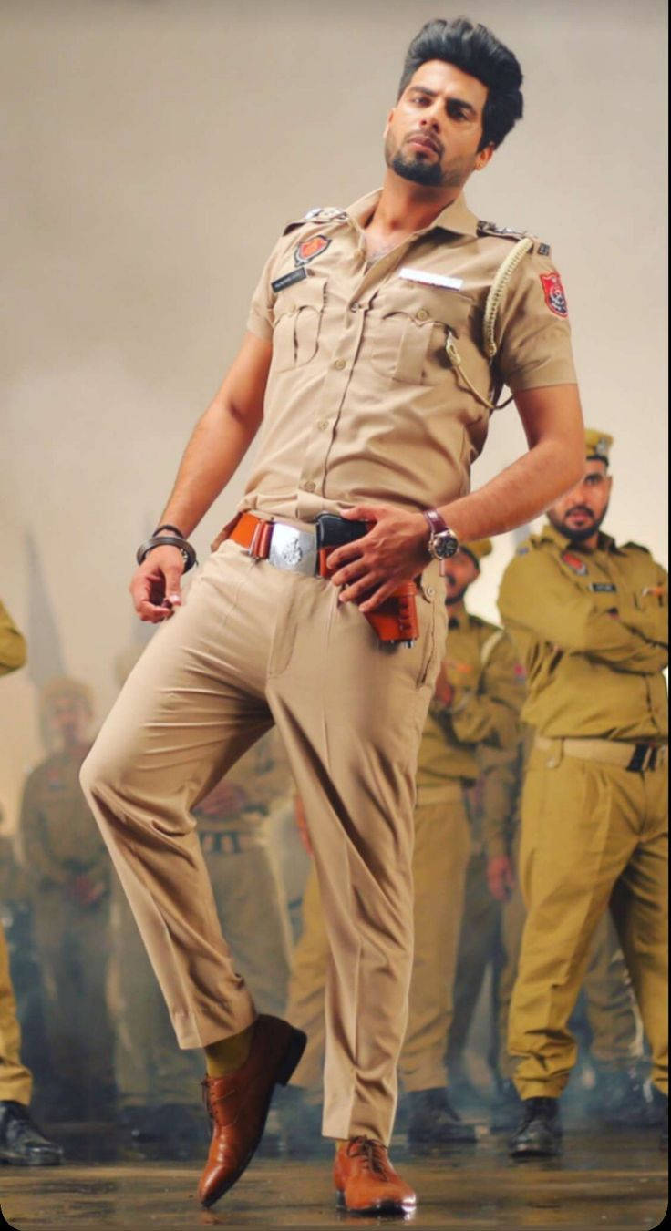 Caption: The Power Of Law: An Indian Police Officer In Action Background