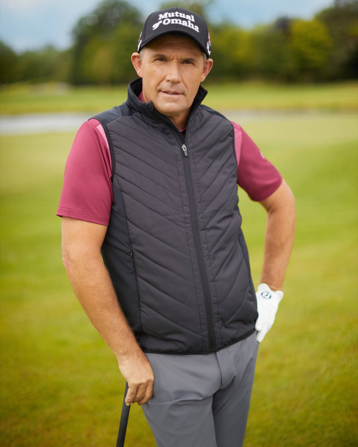 Caption: Three-time Major Champion Padraig Harrington Leaning On His Golf Club. Background