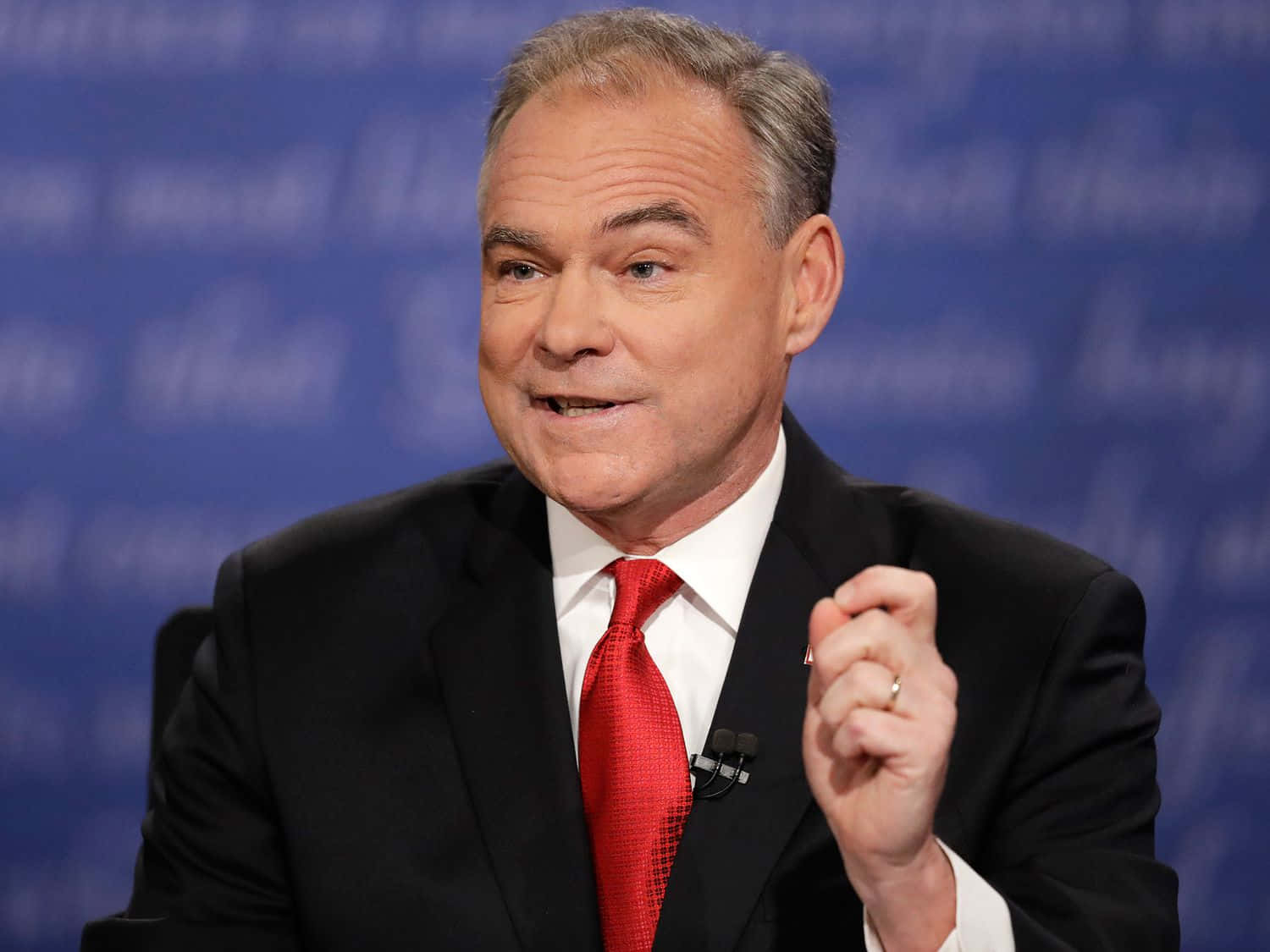Caption: Tim Kaine Posing Against A Dark Blue Background Background