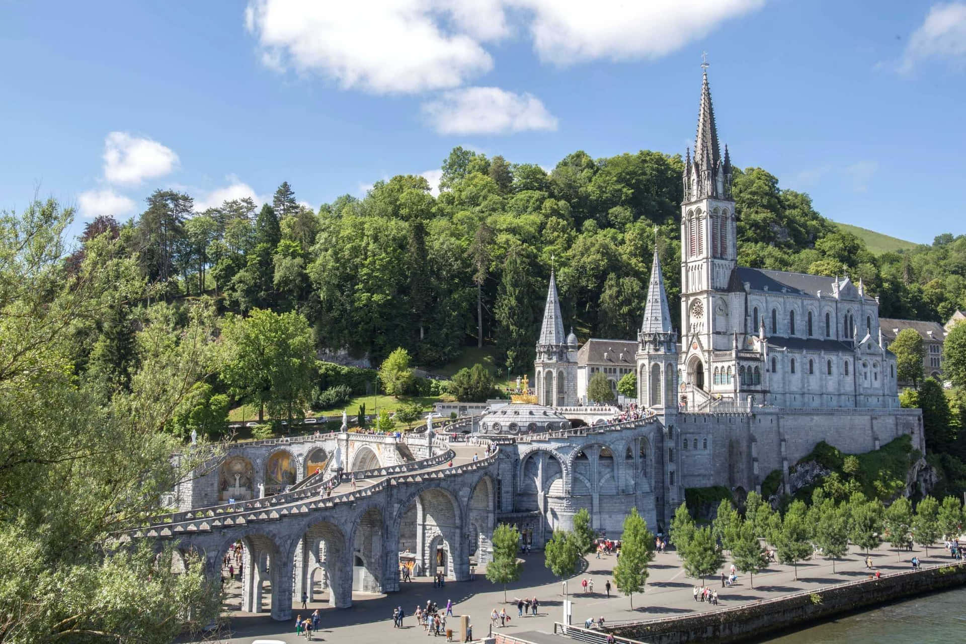 Caption: Tranquil Evening At The Lourdes Sanctuary, France Background