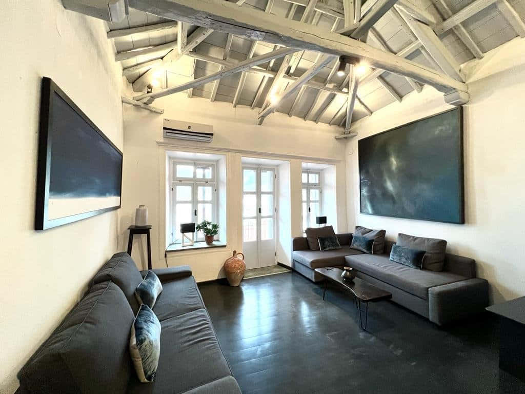 Caption: Tranquil Riverside House At Sunset Background