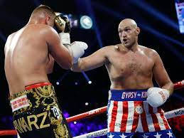 Caption: Tyson Fury Celebrates Victory In Boxing Ring Background