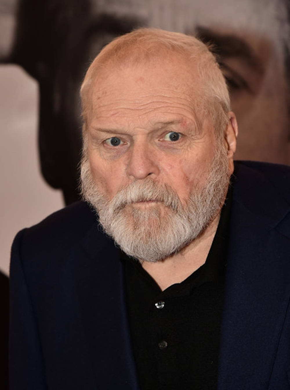 Caption: Veteran Actor Brian Dennehy In A Black Shirt And Gray Beard. Background