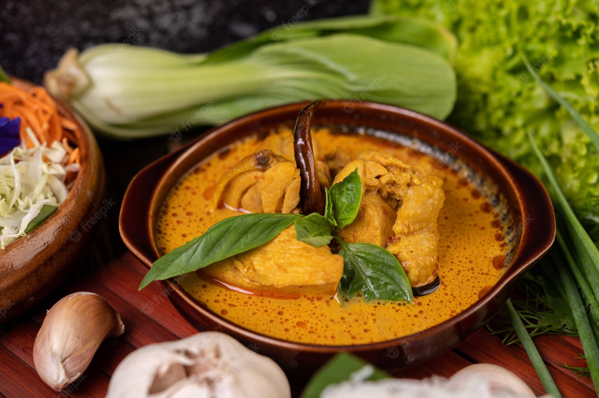 Caption: Vibrant And Spicy Red Thai Curry With Vegetables Background