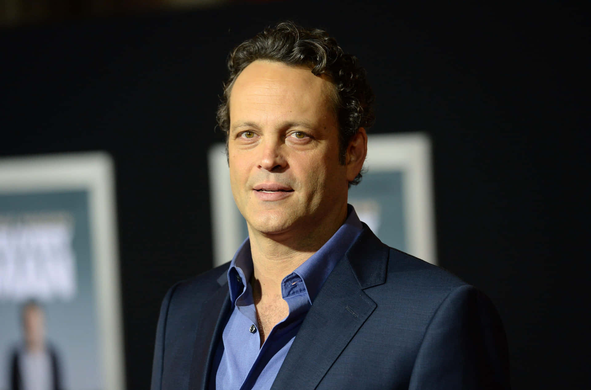 Caption: Vince Vaughn Smiling In A Classic Suit Background