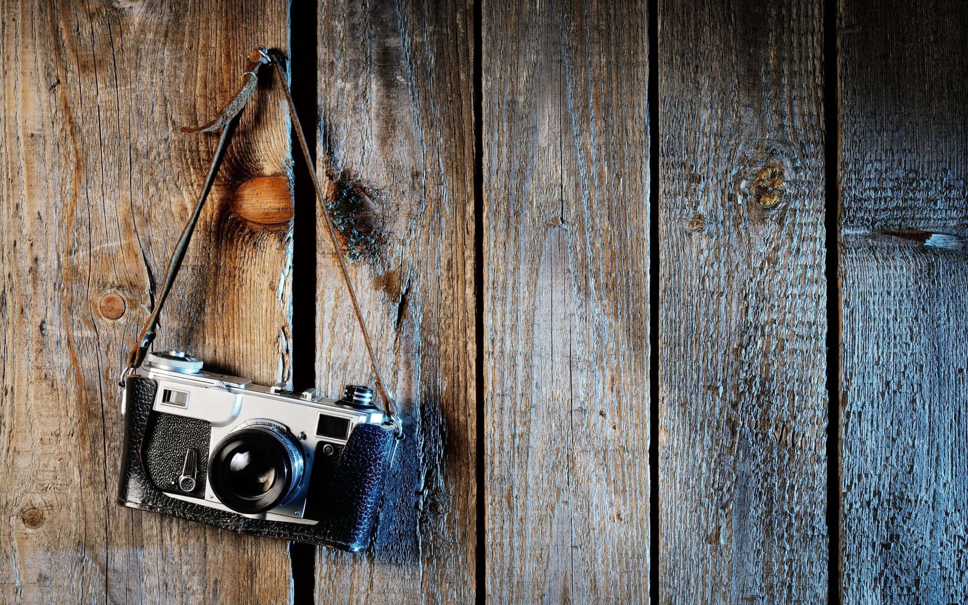 Caption: Vintage Camera Hanging From A Wooden Beam