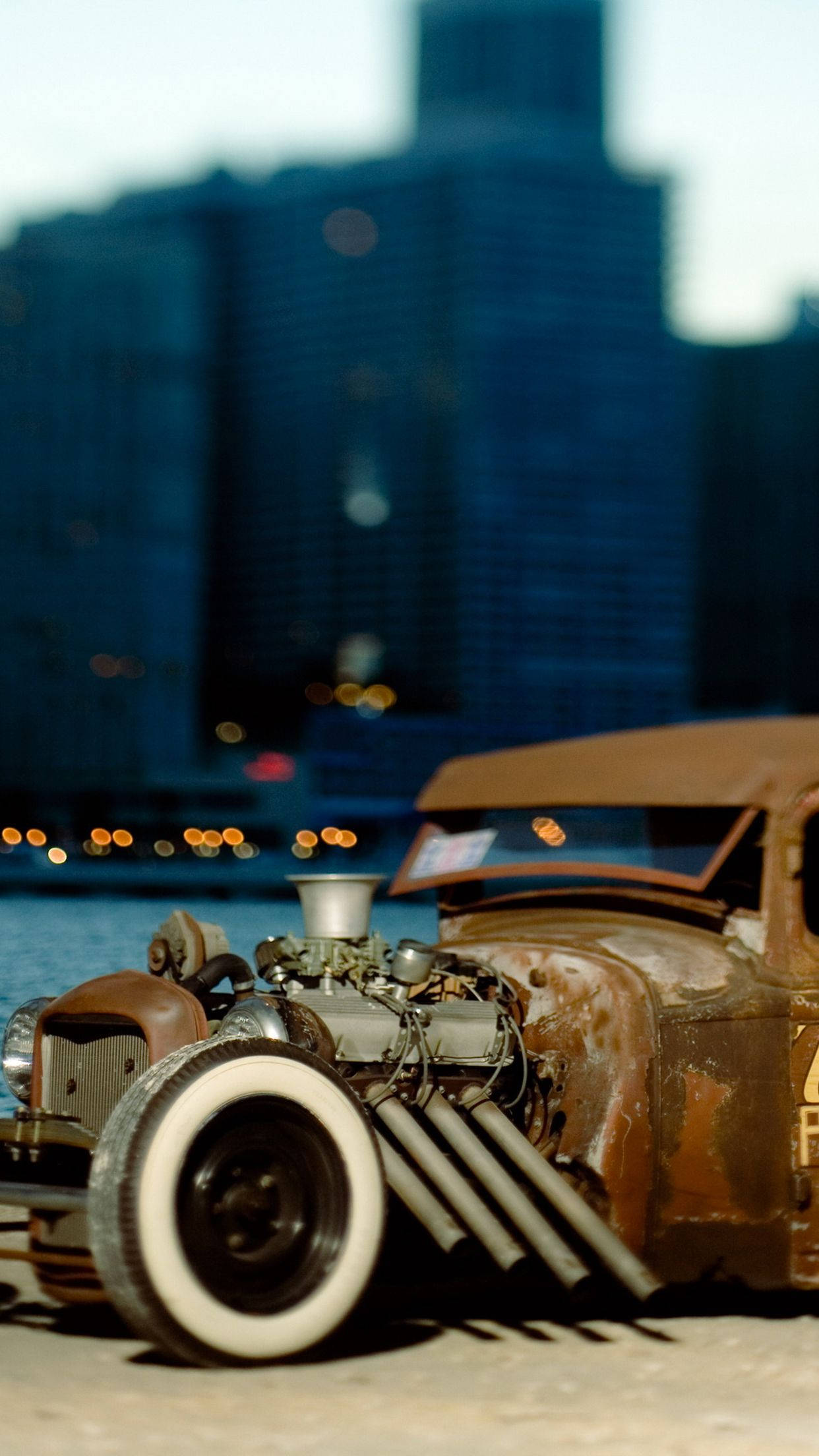 Caption: Vintage Rat Rod Car In City Sunset Background