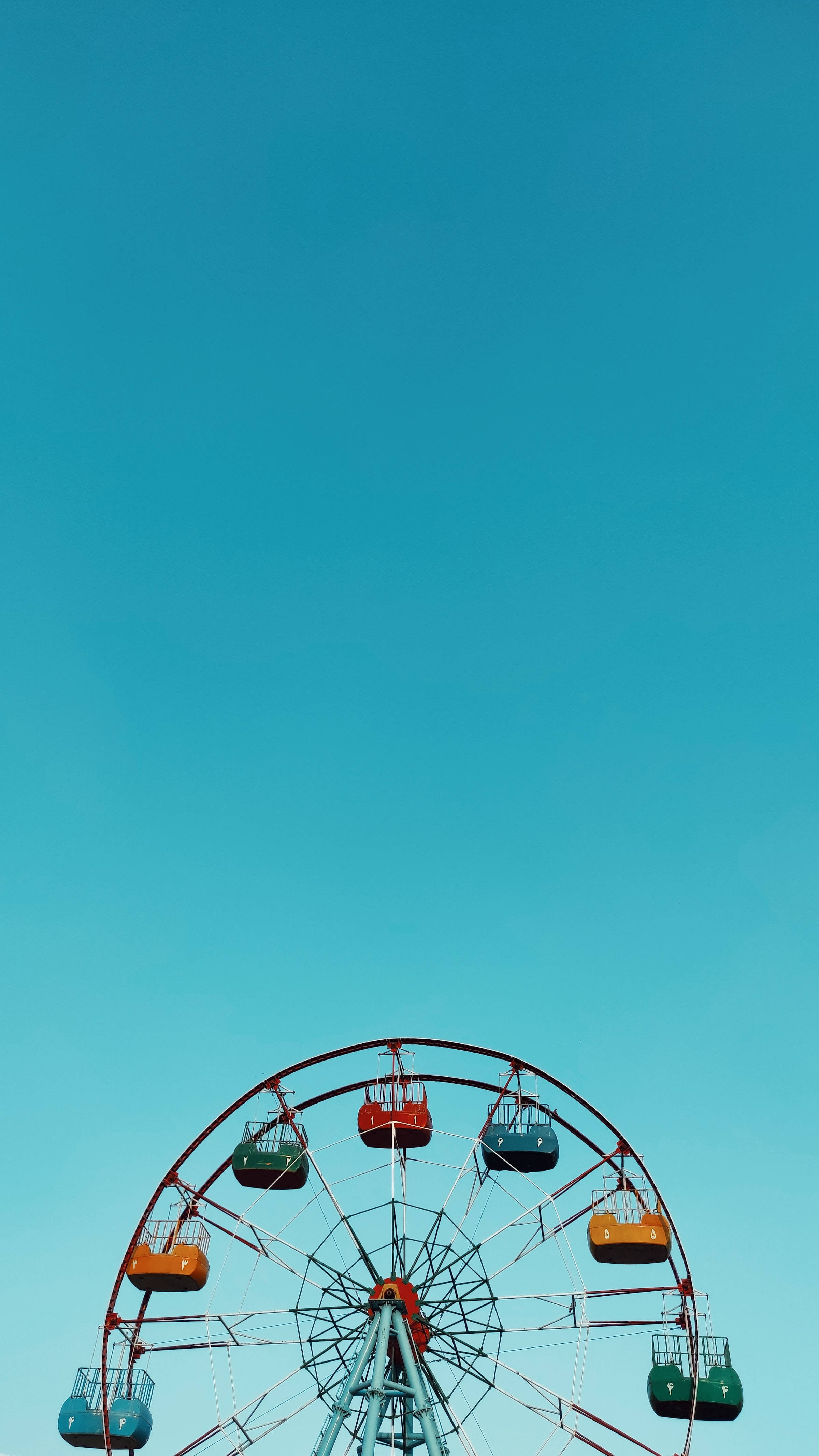 Caption: Whimsical Blue Ferris Wheel In Minimalist Style Background