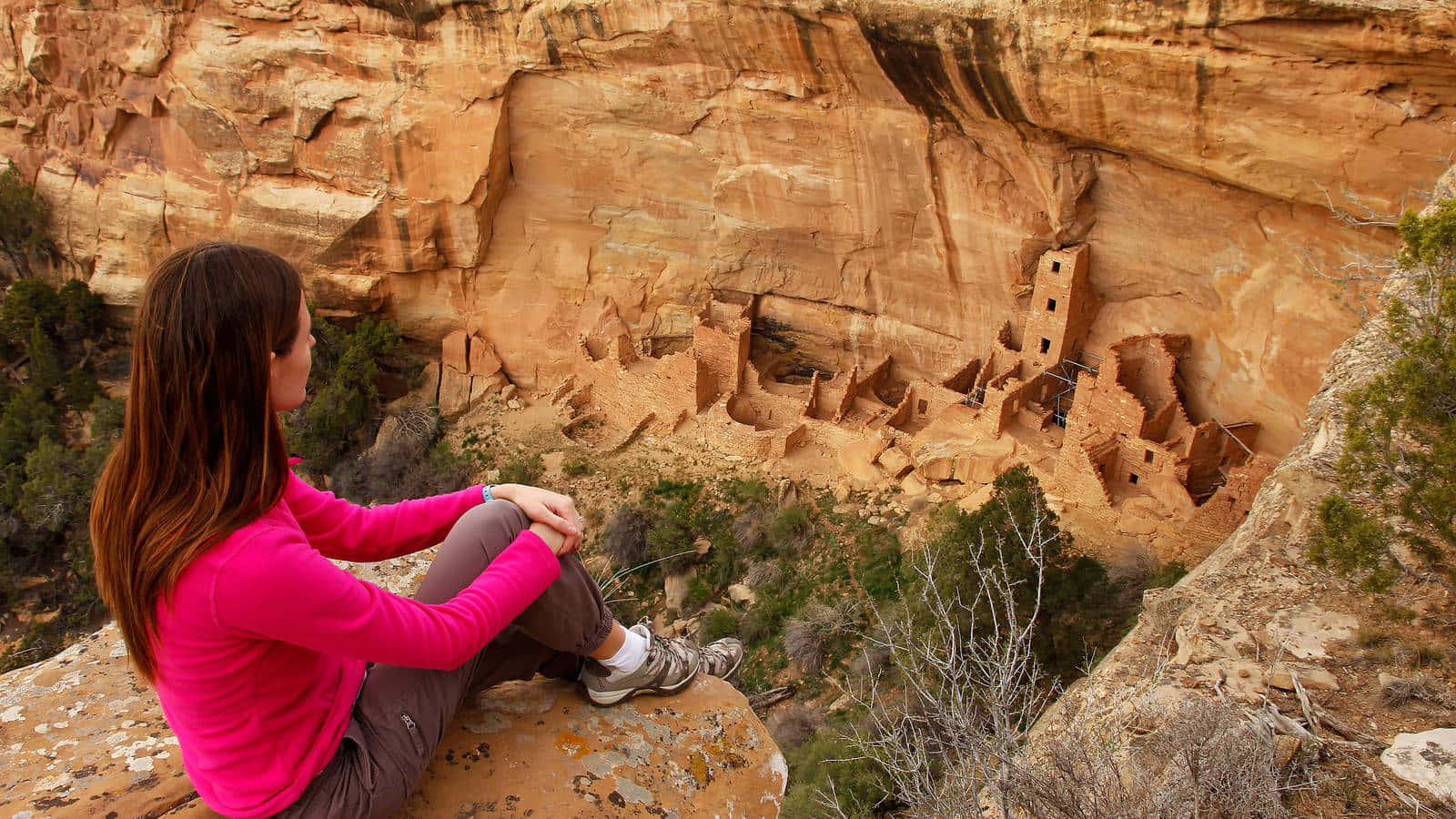 Caption: Woman Embracing Solitude At Mesa Verde National Park Background