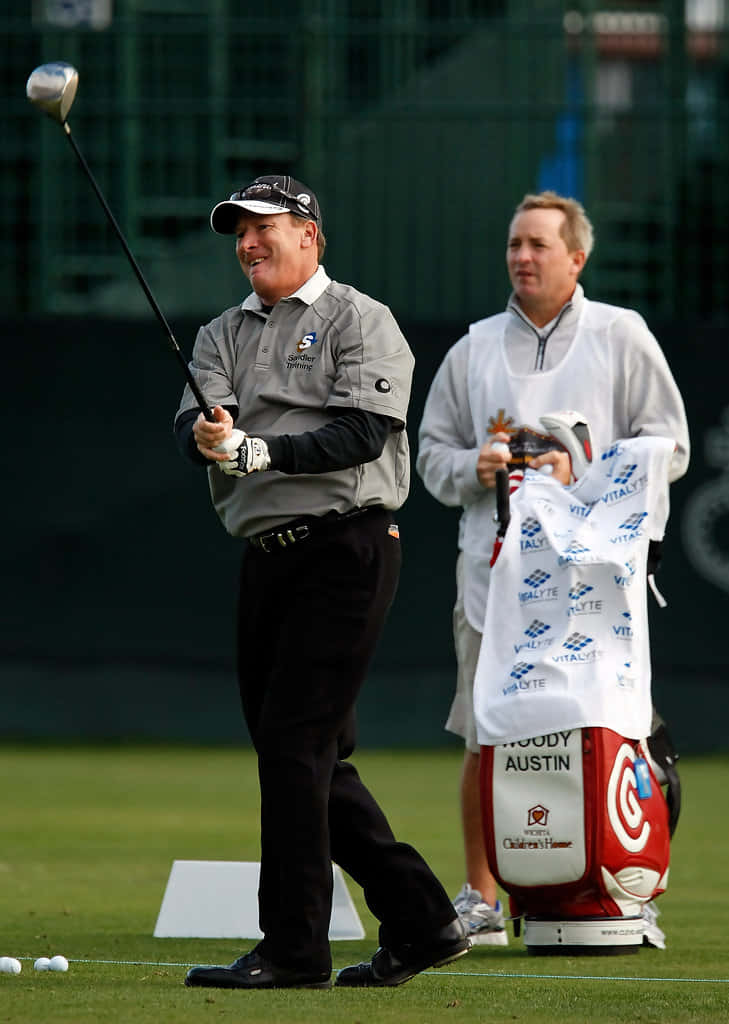 Caption: Woody Austin Perfecting His Swing Before A Match Background