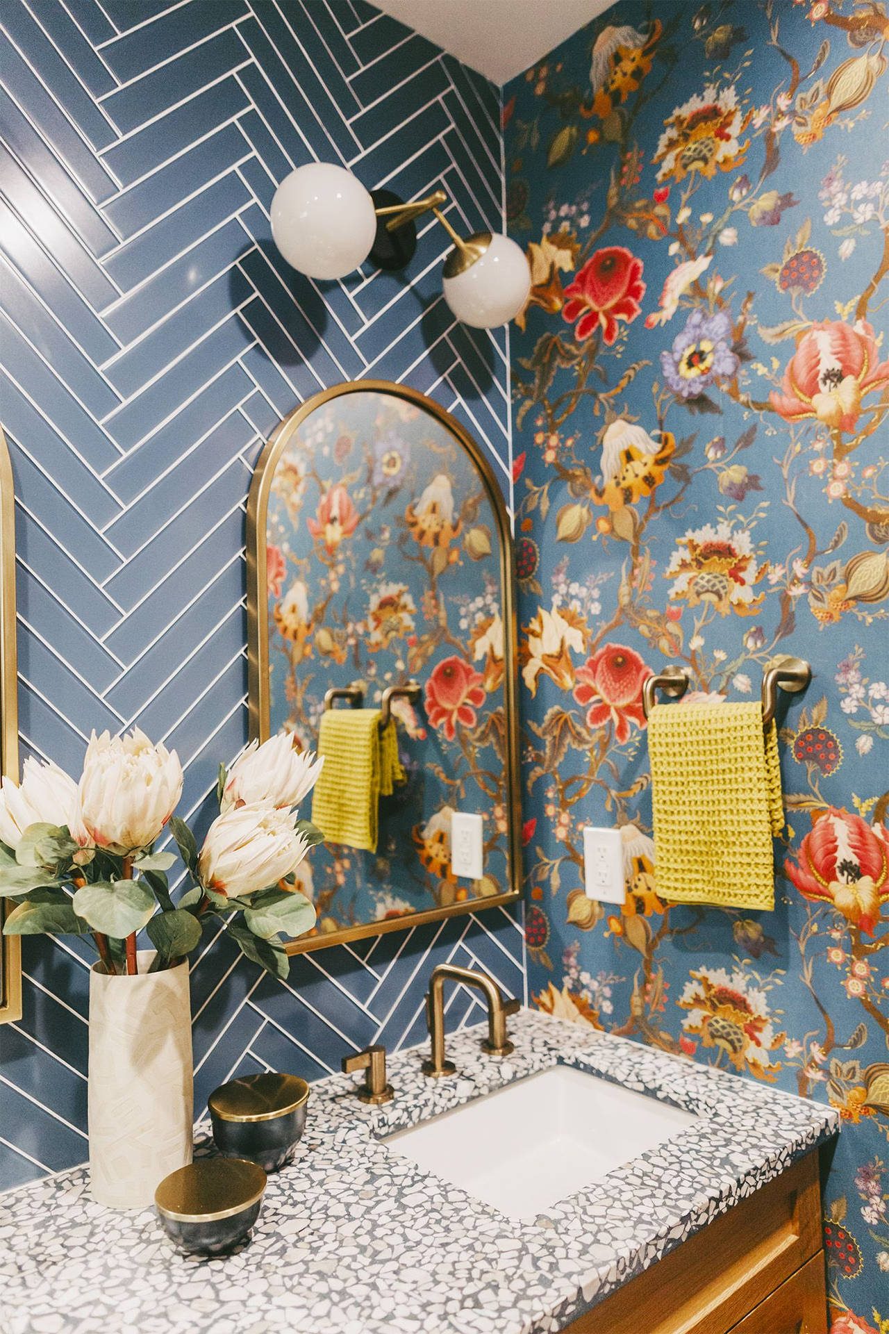 Captivating Arc Mirror In A Flower-patterned Powder Room