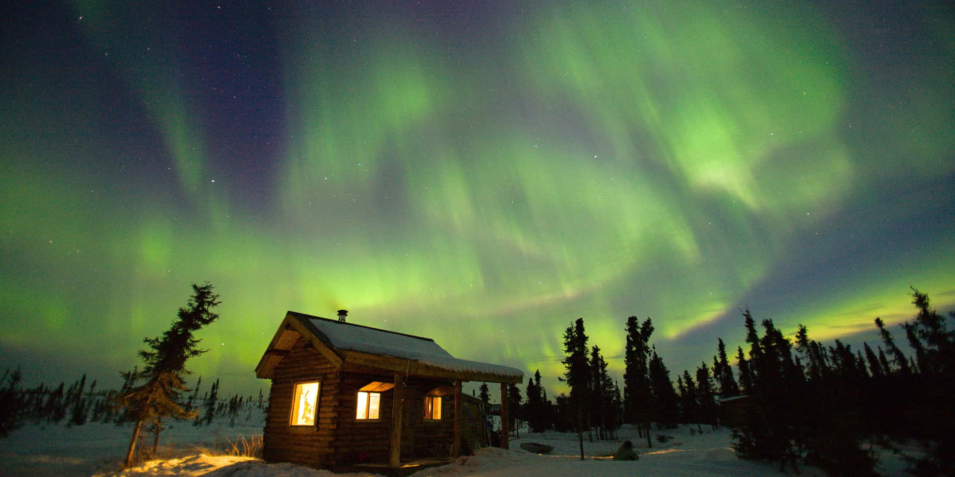 Captivating Aurora Borealis Shimmering Over A Serene Lake Background