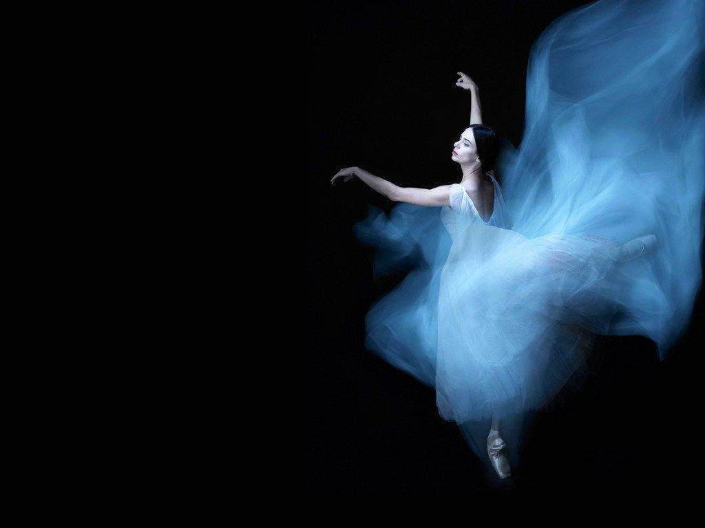 Captivating Ballet Dance In Ethereal Blue Gown Background