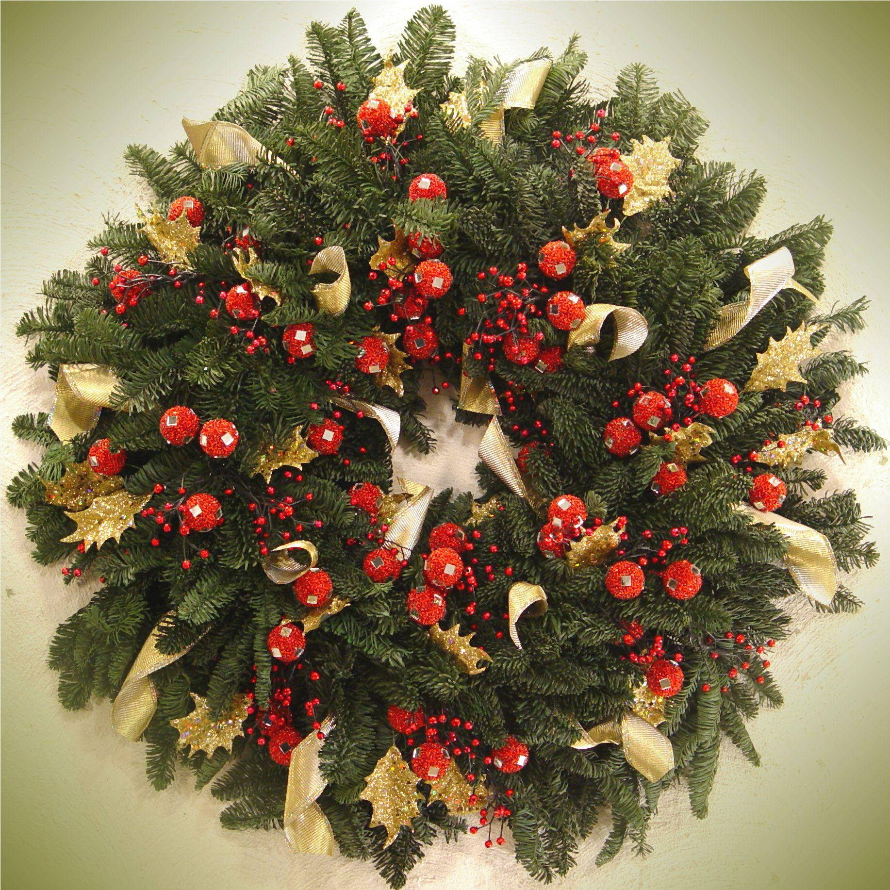 Captivating Christmas Wreath Adorned With Gold Ribbons Background