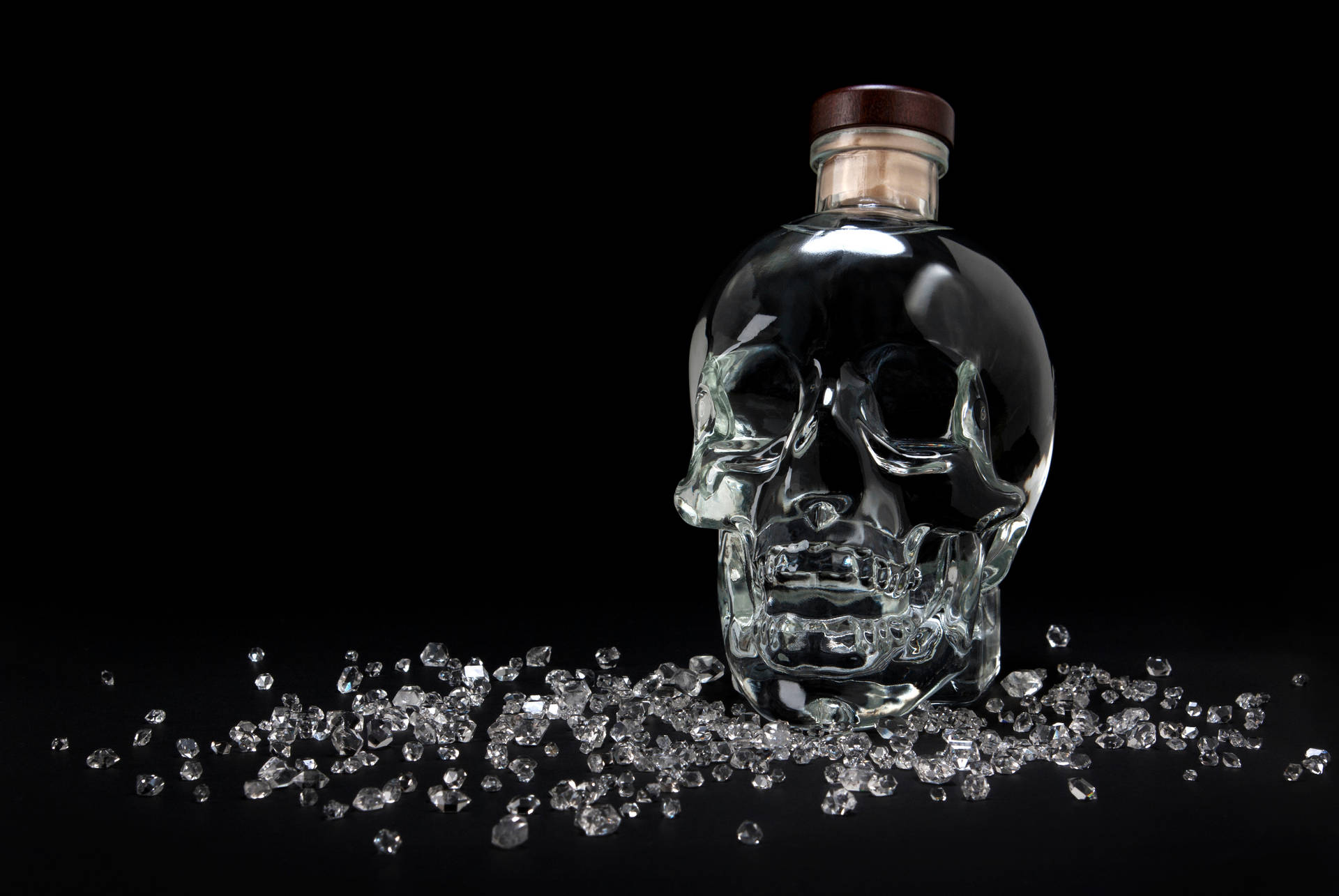 Captivating Crystal Head Vodka With Radiant Shattered Crystals Background