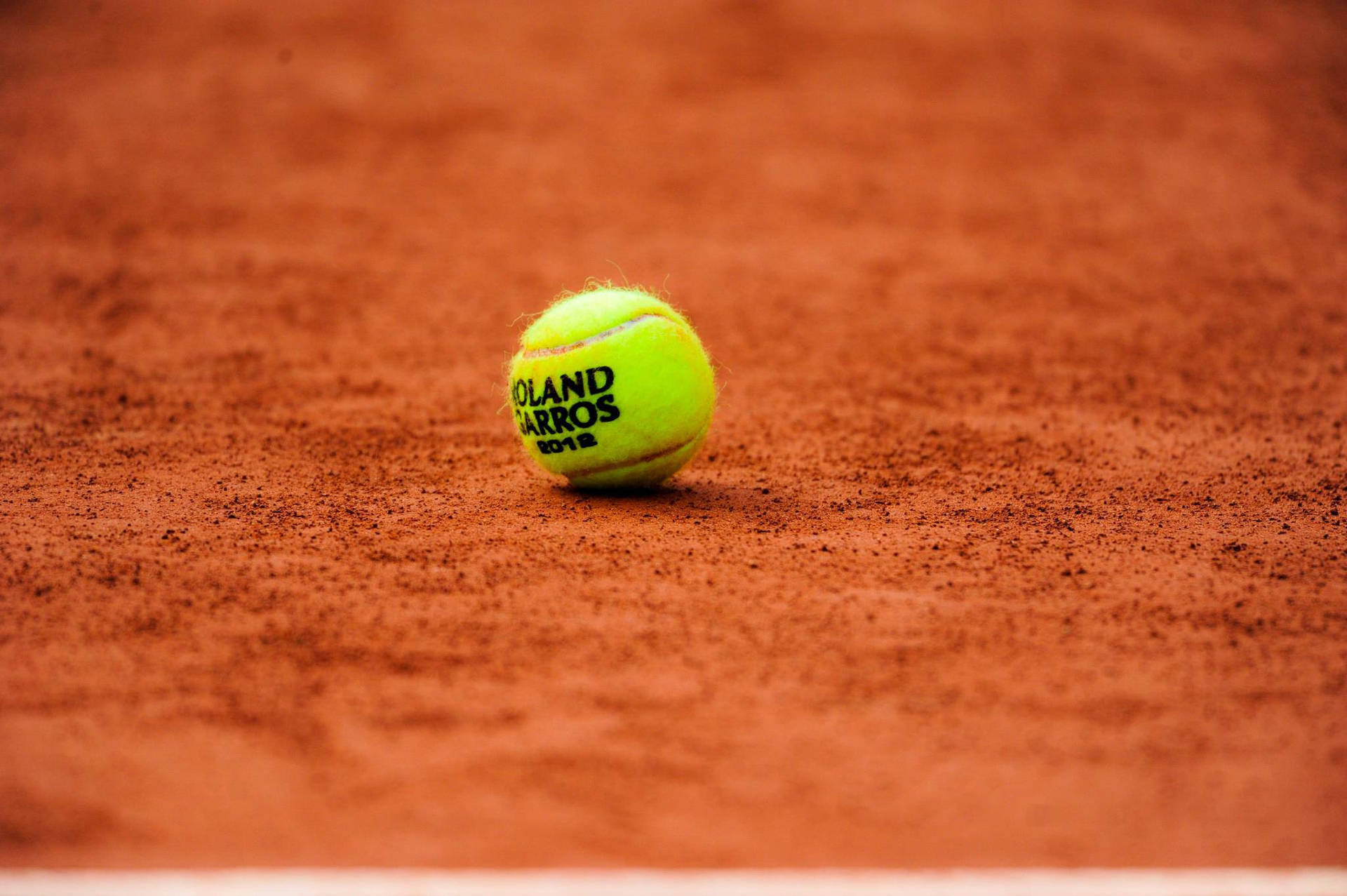 Captivating Focus On Tennis Ball At French Open Background