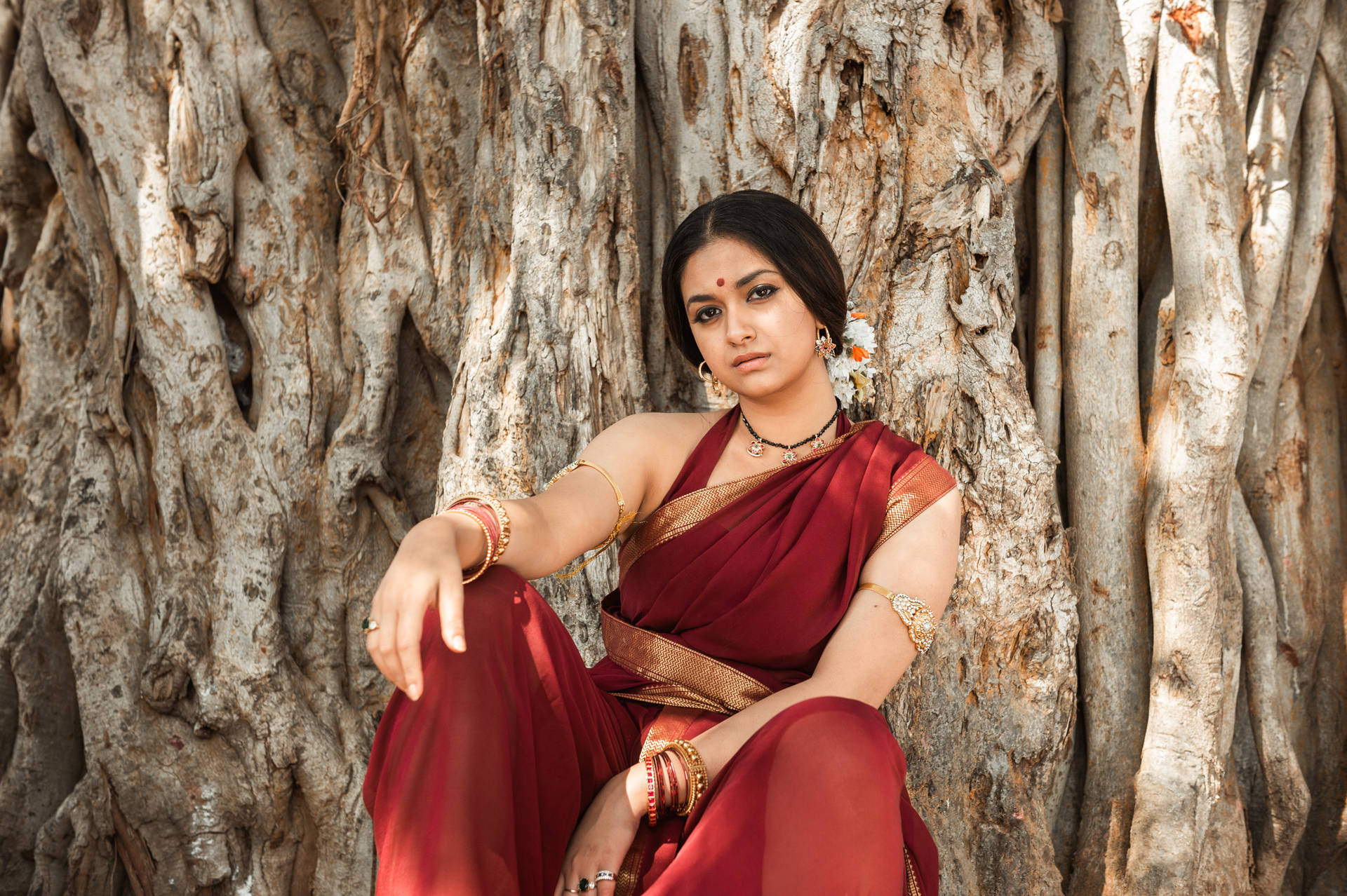 Captivating Keerthi Suresh In Elegant Saree Against An Enchanting Background Background