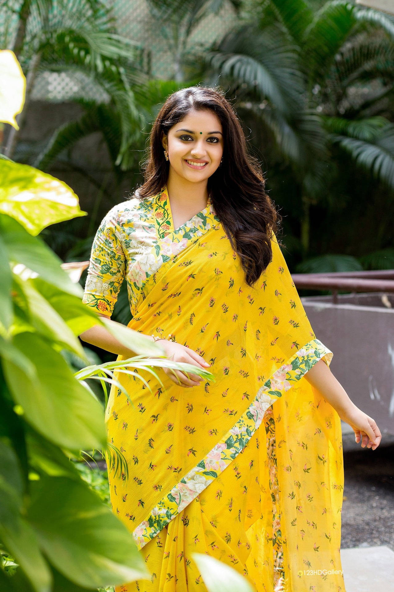 Captivating Keerthi Suresh In Yellow Floral Dress Background