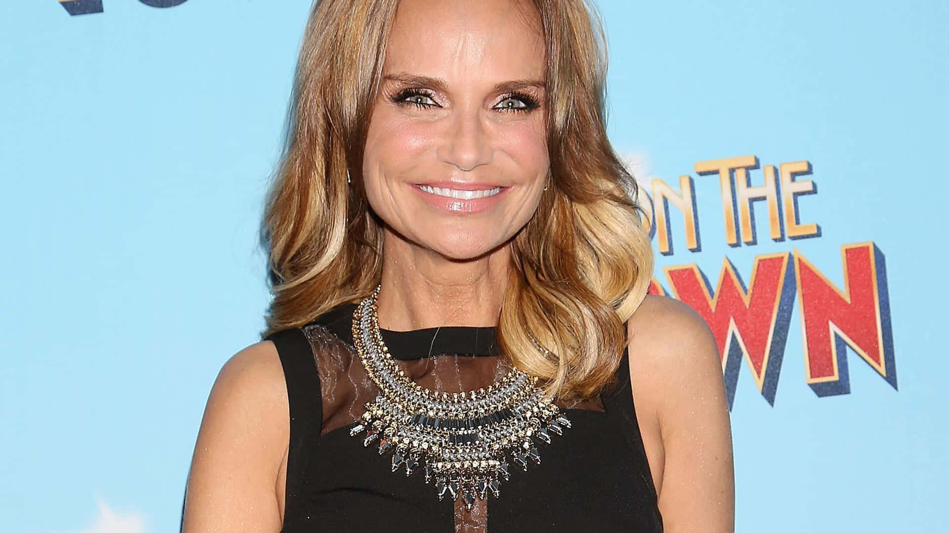 Captivating Kristin Chenoweth Smiling And Sparkling On Red Carpet Background