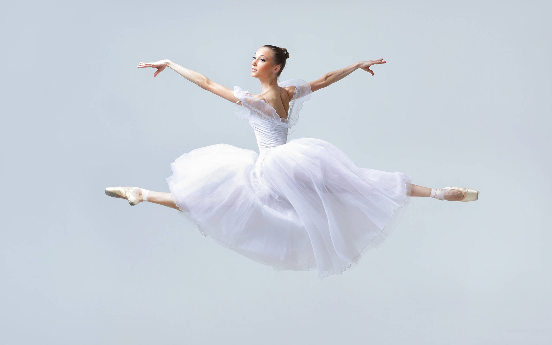 Captivating Leap Of Grace: Ballerina Mid-air Background