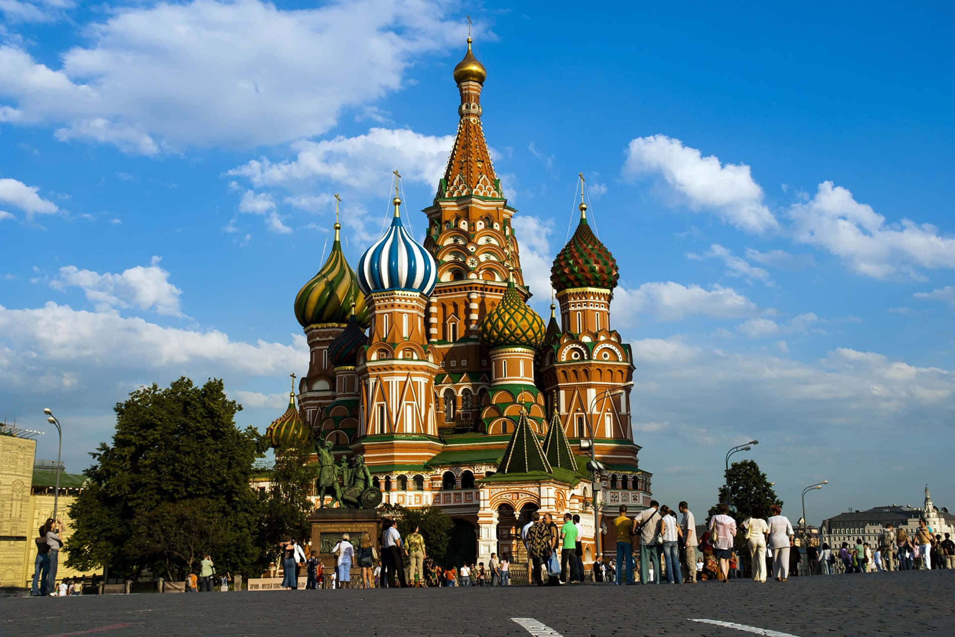Captivating Saint Basil's Cathedral Thriving With Tourist Activity Background