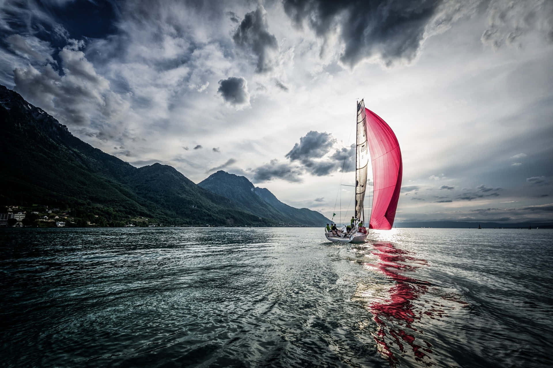 Captivating Serenity: A Blue Sailboat On Peaceful Sea