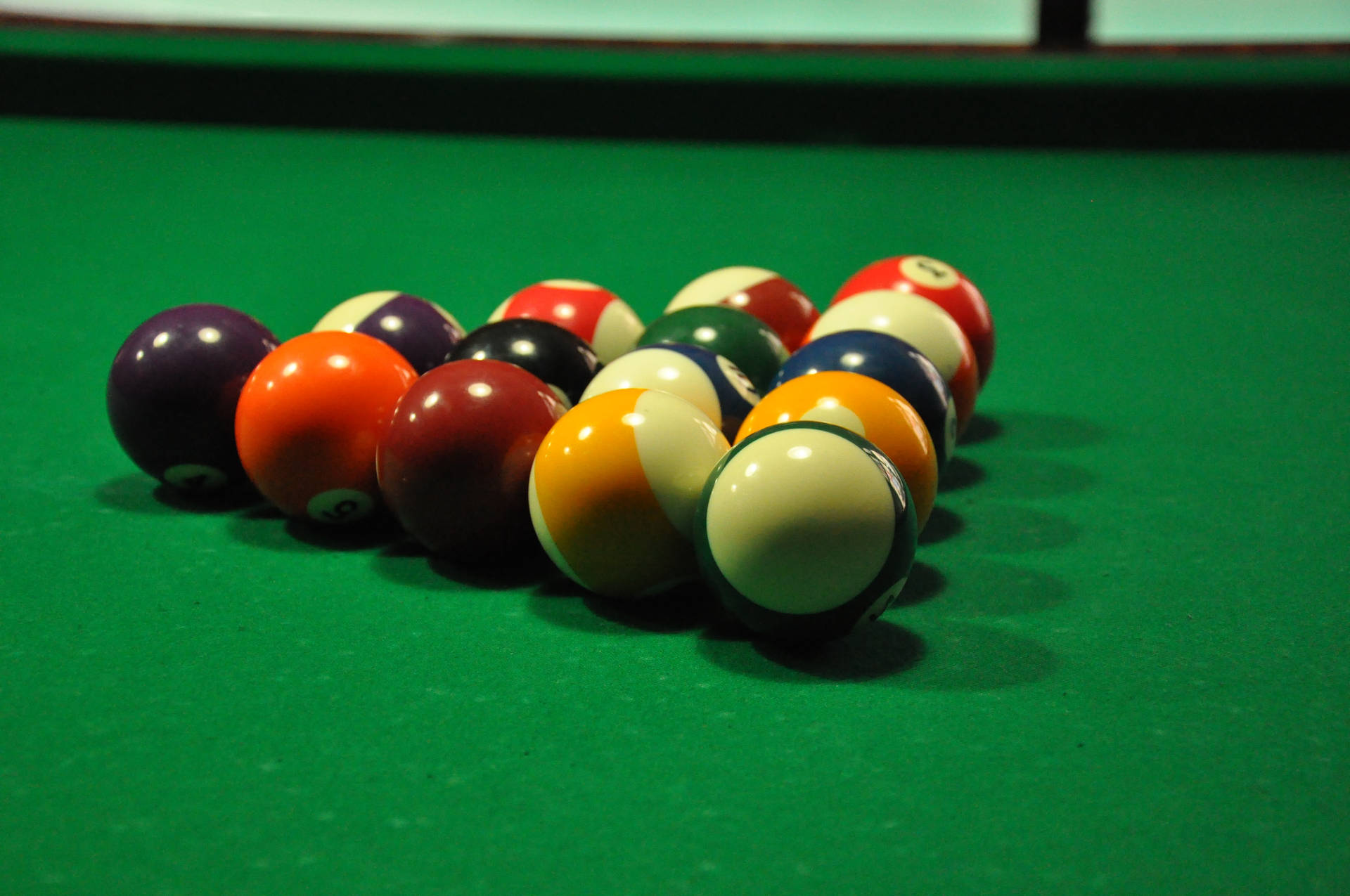 Captivating Shot Of Billiard Balls In Triangle On The Pool Table Background