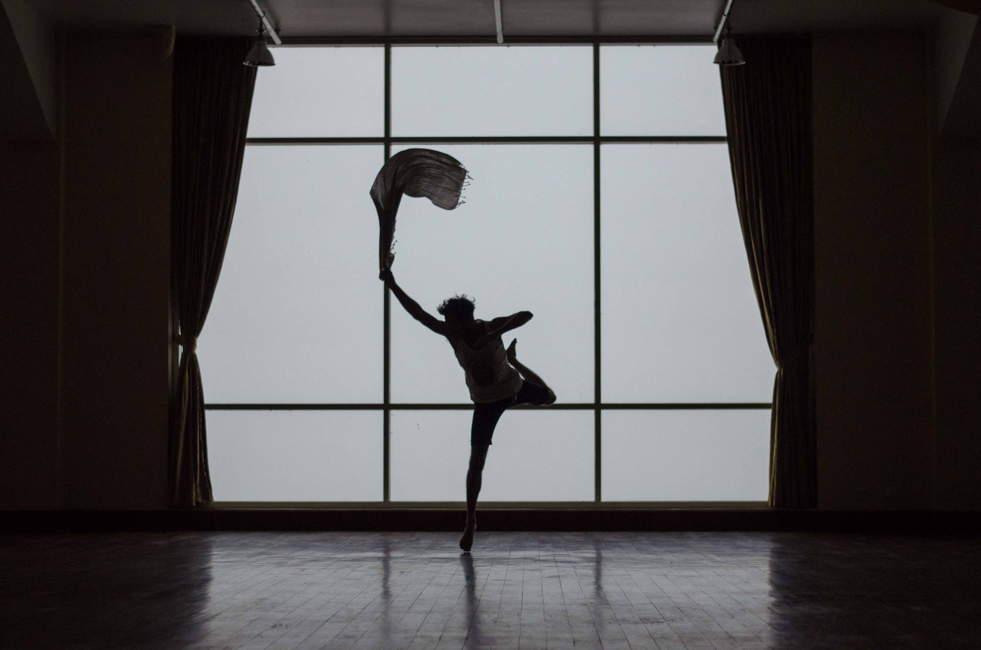 Captivating Silhouette Of A Man Embracing His Dance Pose Background